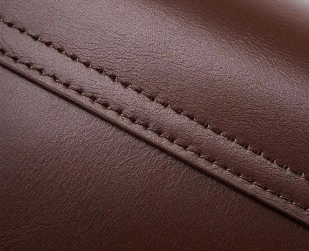 Close-up of brown leather with visible stitching