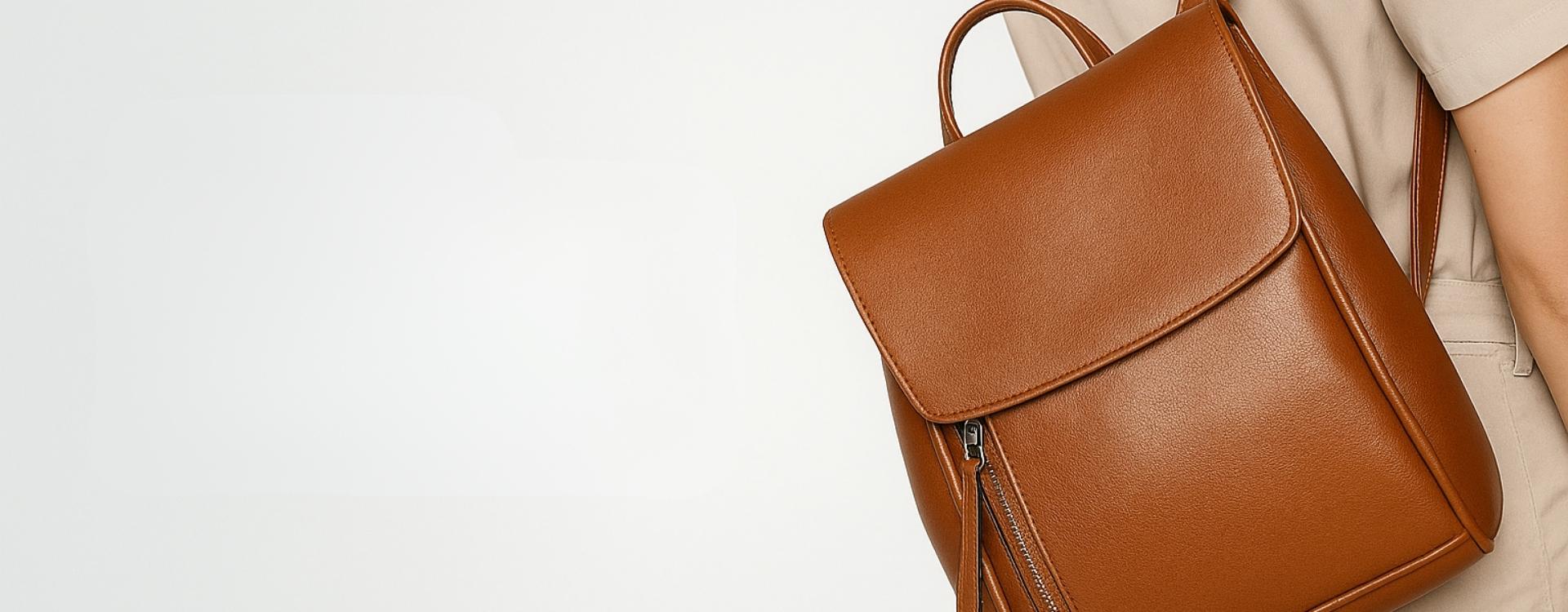 Brown leather backpack on a light gray background